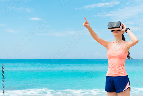 beautiful happy woman runner wearing VR technology