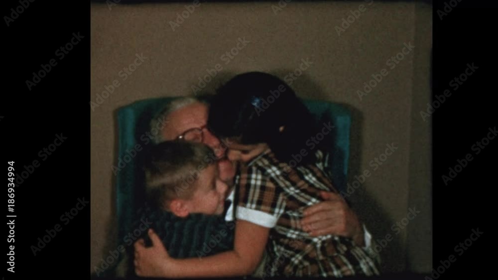 1956 Grandfather gets hugs and kisses from grandchildren