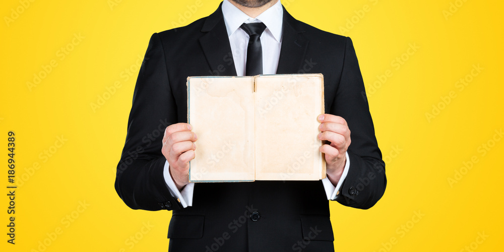 Unrecognizable businessman holding blank piece of paper with copy space Unrecognizable businessman holding blank piece of paper with copy space