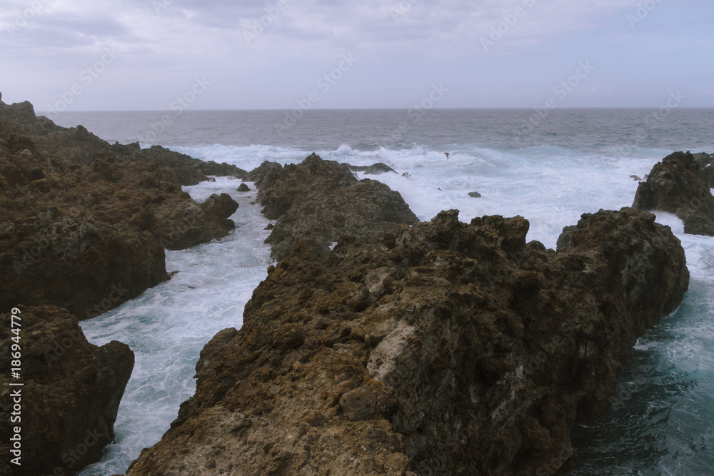 Breaking waves on coastline in dark cloudy  weather