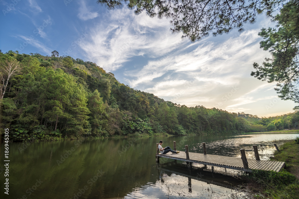 Fototapeta premium Man wiht tablet is relax in Pang Ung Lake
