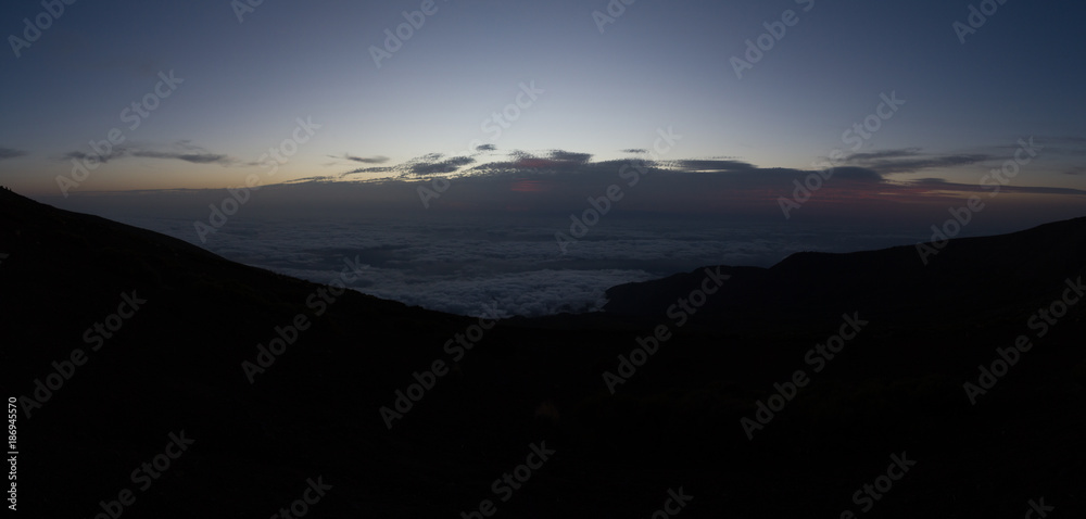 Cloud inversion in mountains during dawn before sunrise