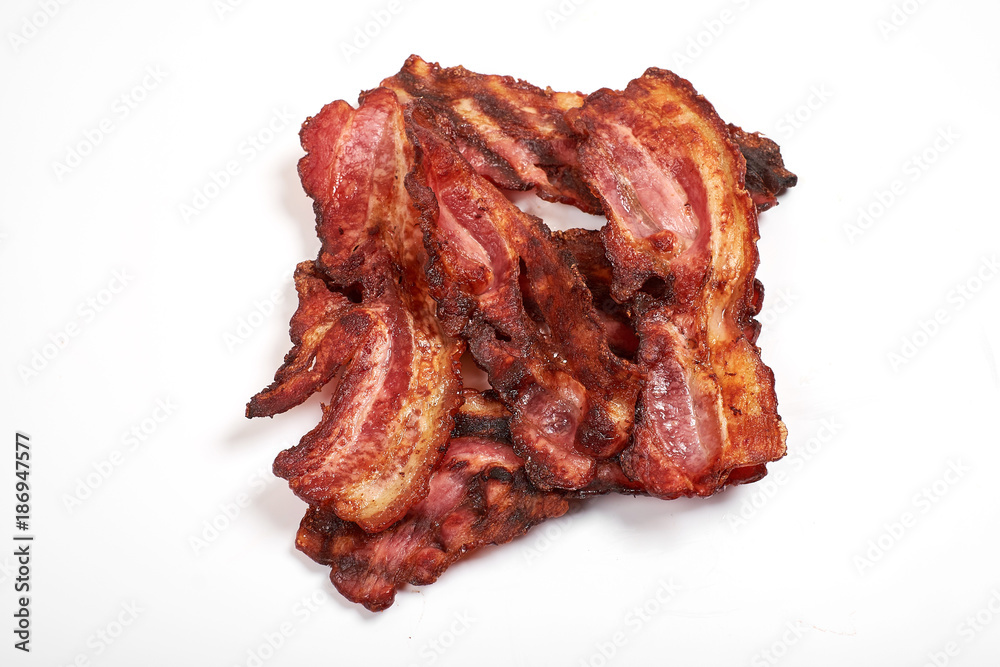 crispy fried bacon isolated on a white background. crispy fried bacon isolated on a white background.