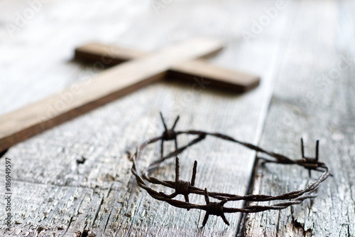 Easter abstract background with  crown of thorns and cross on wooden planks