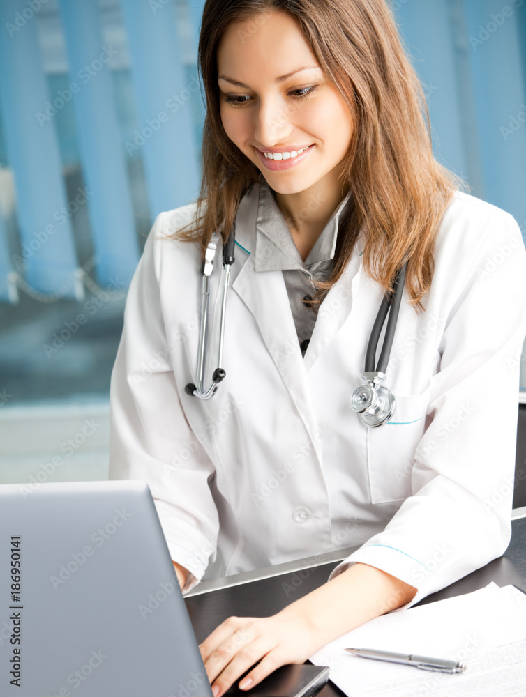 Cheerful female doctor with laptop Cheerful female doctor with laptop
