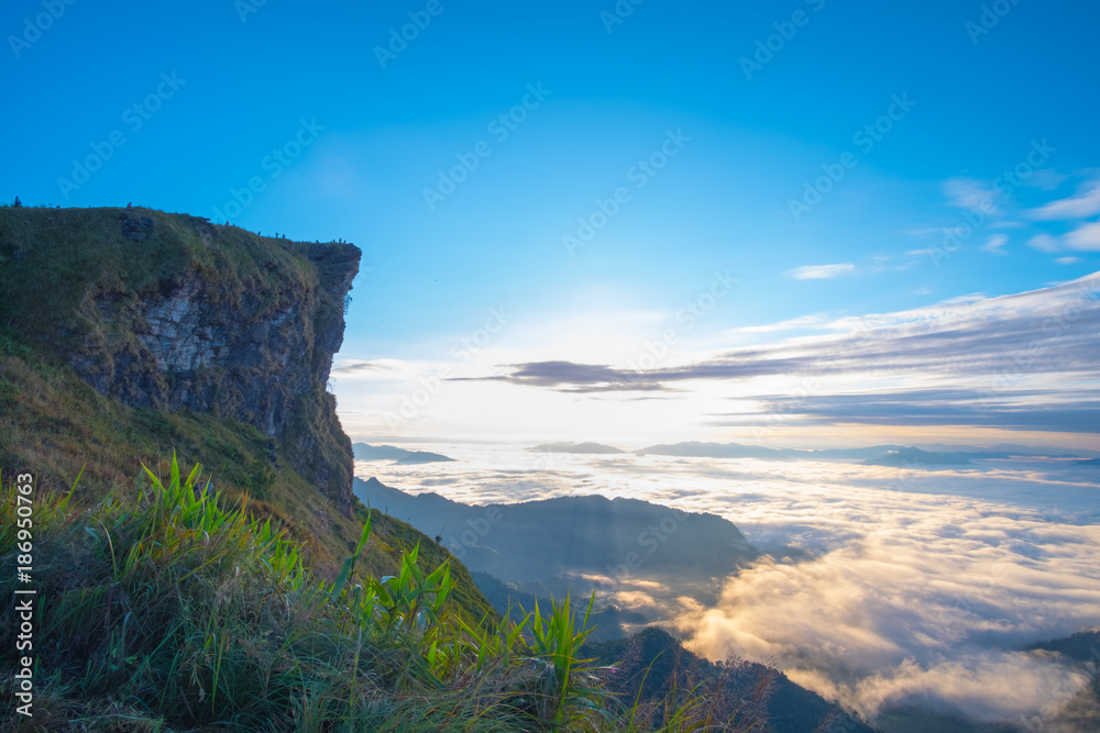 Beautiful sunrise scene at high mountain with yellow clouds and blue sky, Phu chi fah Chiangrai Thailand