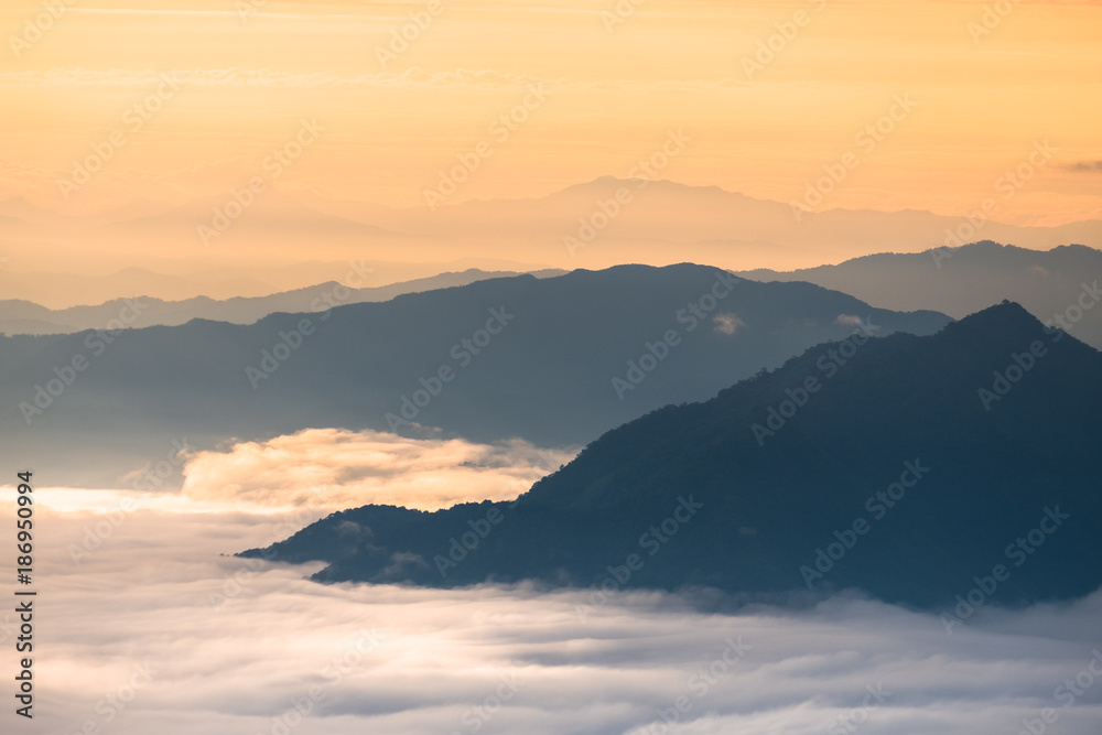 Beautiful sunrise scene at high mountain with yellow clouds and blue sky, Phu chi fah Chiangrai Thailand Beautiful sunrise scene at high mountain with yellow clouds and blue sky, Phu chi fah Chiangrai Thailand