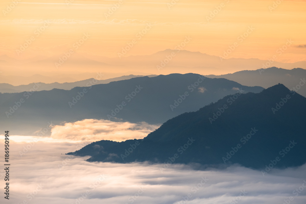 Beautiful sunrise scene at high mountain with yellow clouds and blue sky, Phu chi fah Chiangrai Thailand