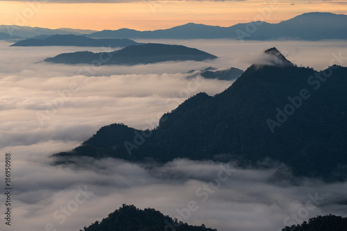 Beautiful sunrise scene at high mountain with yellow clouds and blue sky, Phu chi fah Chiangrai Thailand photo