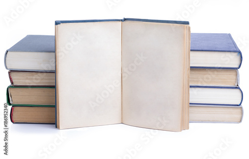A pile of old books and one opened