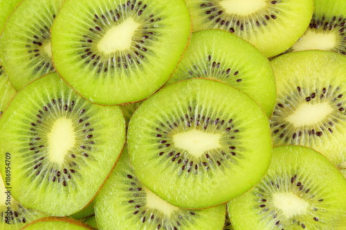 slices of fresh green kiwi fruits food background texture