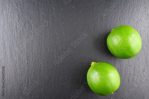 fresh lime fruit on a slate plate food background texture photo