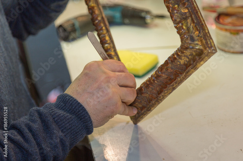 Craftsman Hands Working on Wooden Vintage Frame