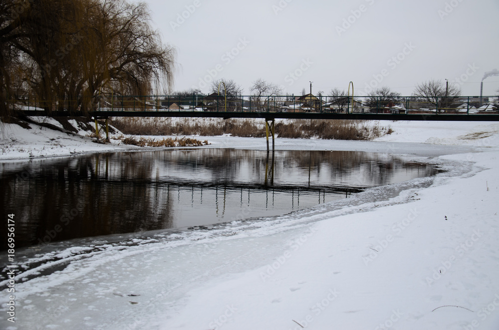 Footbridge across the frozen river