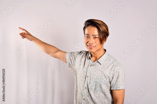 Indian male pointing at something with a happy expression, Pune, Maharashtra photo