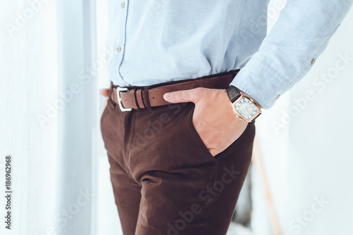 cropped image of businessman with hands in pockets