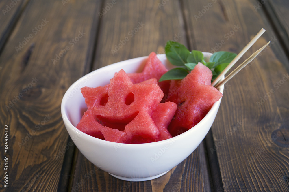 Summer fruit snack of watermelon and frozen berries. Watermelon slices on a stick.