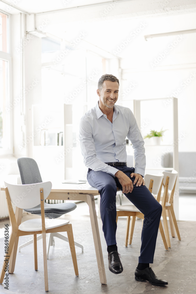 Portrait of smiling businessman in office Portrait of smiling businessman in office