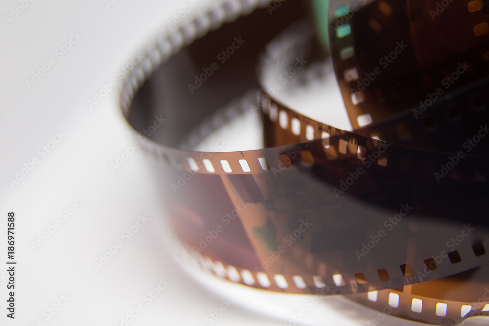 A beautiful closeup of an analogue photo film on a white background. Shallow depth of field.