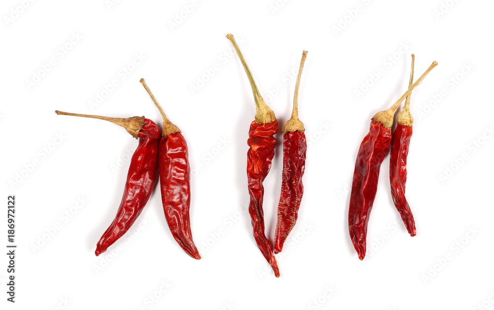 Dry red hot chili peppers, pile isolated on white background, top view Dry red hot chili peppers, pile isolated on white background, top view