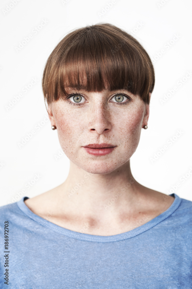 Biometric passport photo of a green-eyed read-haired woman with freckles and bangs Biometric passport photo of a green-eyed read-haired woman with freckles and bangs