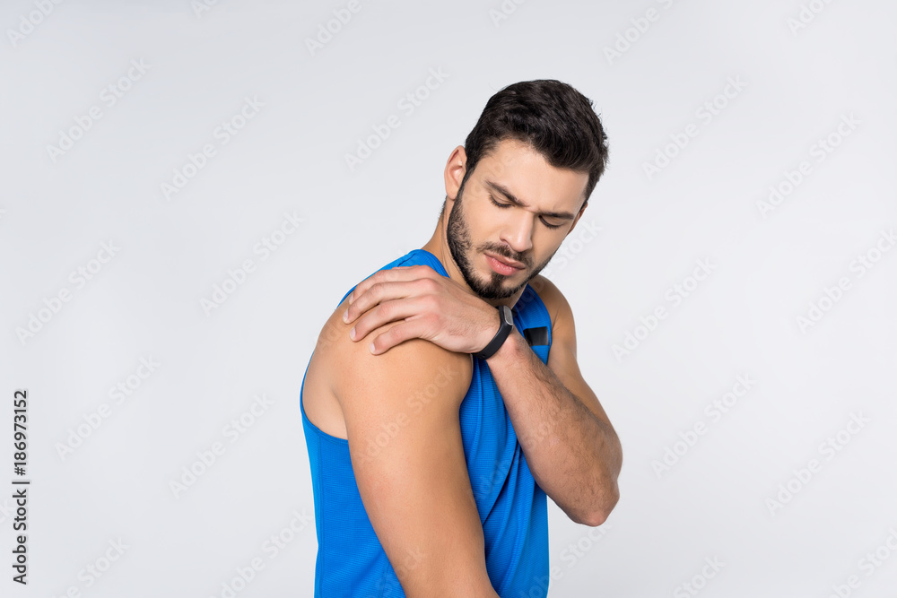 young man with pain in shoulder isolated on white young man with pain in shoulder isolated on white