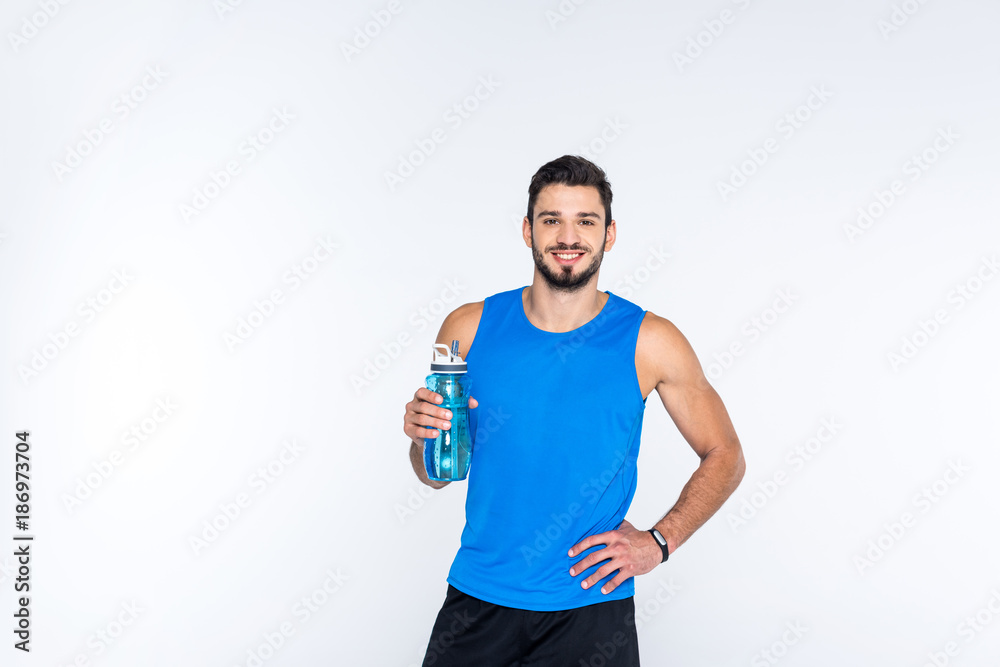smiling young man with fitness bottle isolated on white