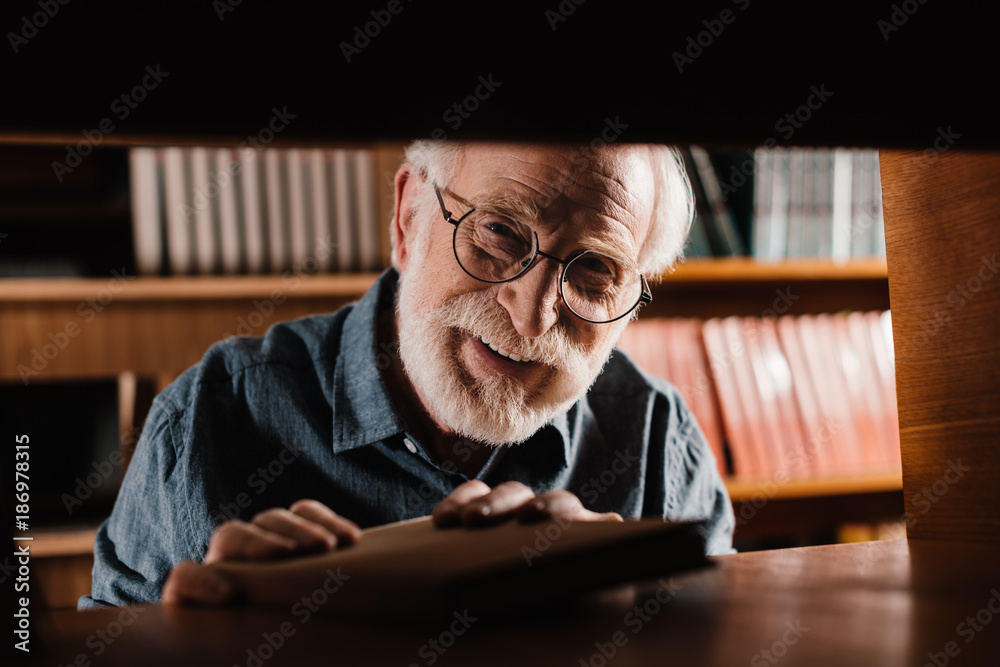 Senior man at library