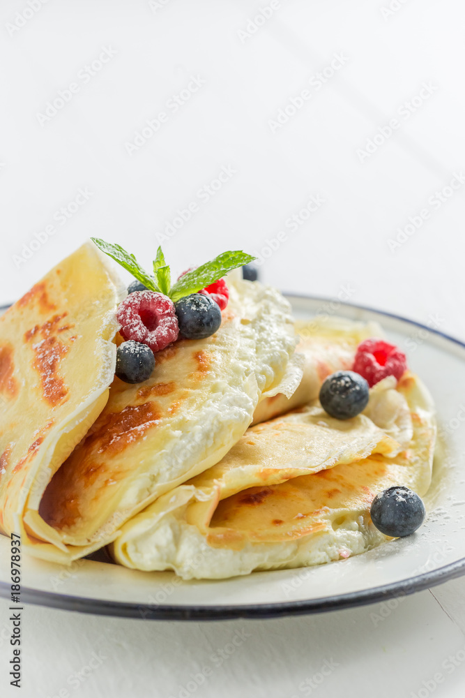 Delicious pancakes with cottage cheese, berries and powder sugar