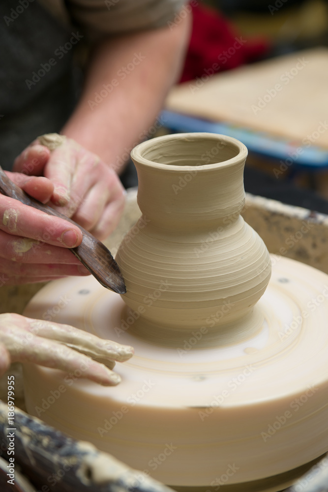 Hands of a potter, creating a pot of clay Hands of a potter, creating a pot of clay