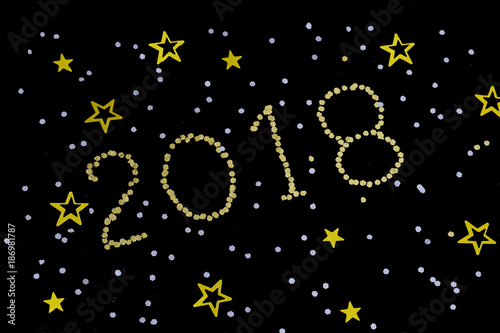 Bright gold figures 2018, New Year with glitter stars on dark background.