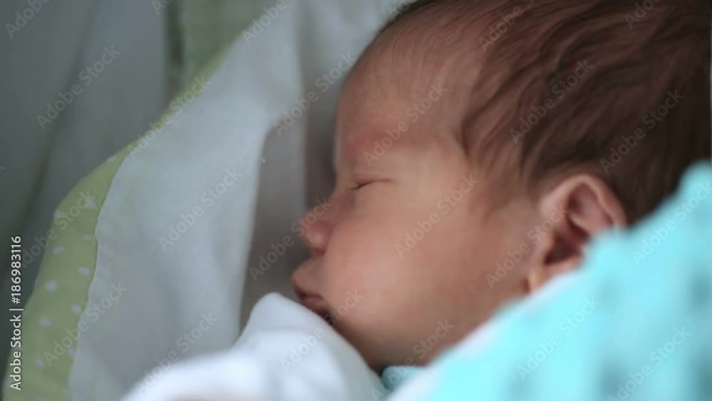 Adorable newborn baby stretching his muscles while waking up
Adorable newborn baby stretching his muscles while waking up