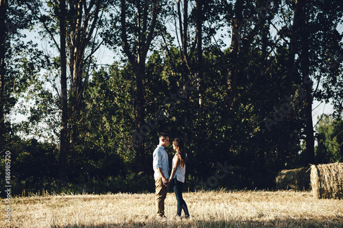 Romantic couple looking each other in the middle of the field in Madrid, Spain photo