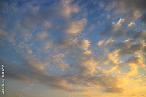 Beautiful blue sky with colorful cloud with sunlight in the evening. Soft focus. Nature background concept.  © Aungsumol