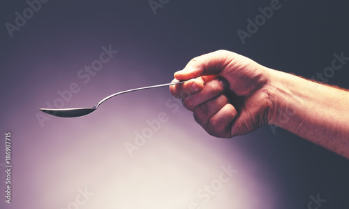 a hand holding spoon