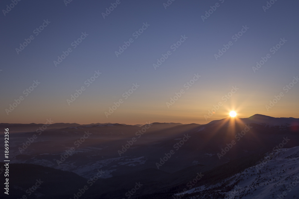 Sunrise in the mountains. The sun rises from behind the mountains. Western Ukraine. Carpathians.