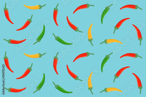 seamless pattern of red green and yellow chili pepper in flat icon design on blue color background