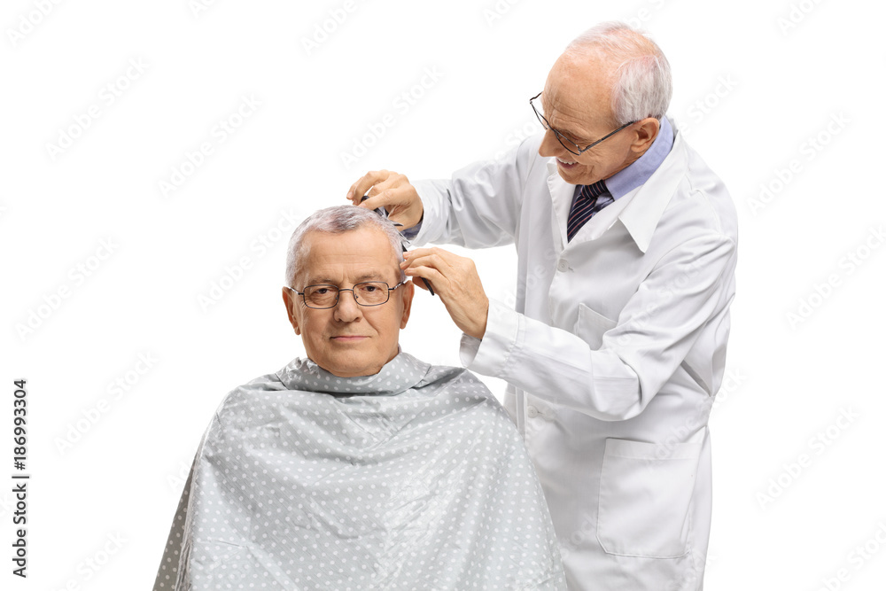 Fototapeta premium Mature man with a barber cutting his hair