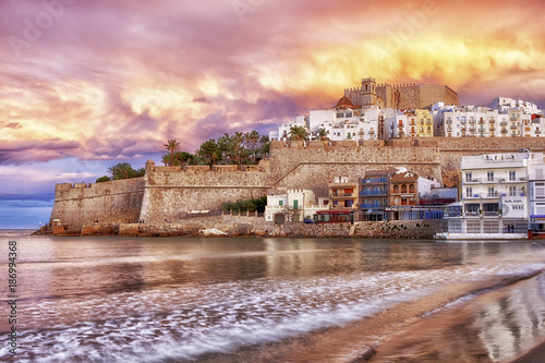 Spain, Province of Castellon, Peniscola, Costa del Azahar, Old town with castle, dramatic sky in the evening