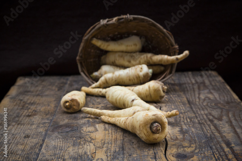 Organic parsnips on wood