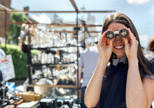 UK, London, Portobello Road, portrait of laughing woman looking through old binoculars photo