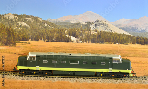 A Class 55 Deltic model diesel train set against a scenic backdrop