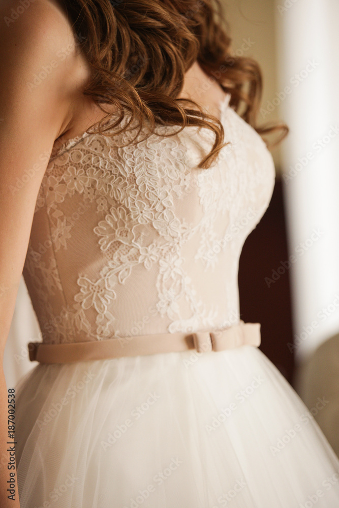 The bride in a lacy beige dress. 