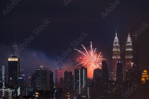 Photography KUALA LUMPUR, MALAYSIA - 1ST JANUARY 2018; Fireworks explode near Malaysia's landmark Petronas Twin Towers during New Year celebrations in Kuala Lumpur