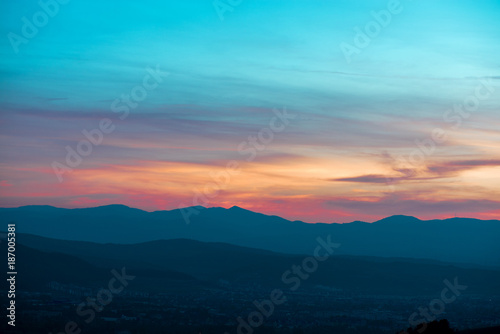 Romantic, bright and colorful sunset over a mountain range in Transilvania. Beautiful, colorful autumn background. © lainen