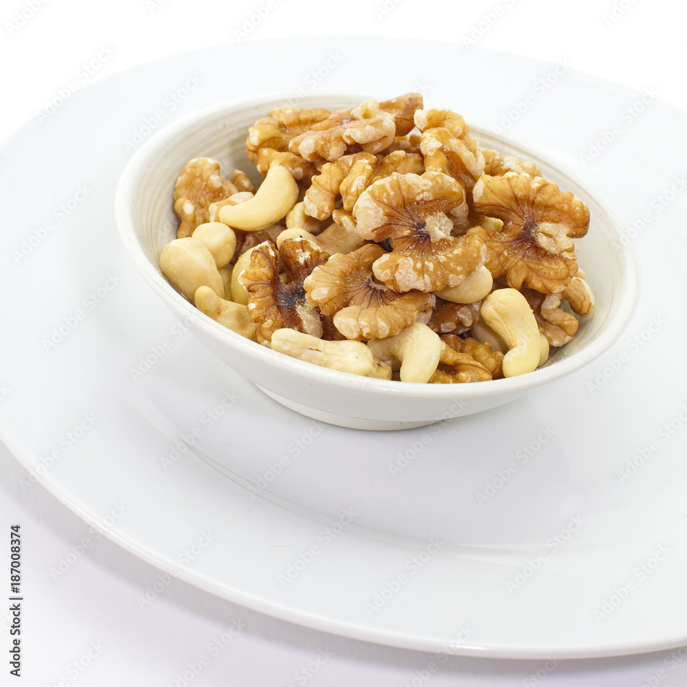 Assorted mixed nuts in white bowl Assorted mixed nuts in white bowl