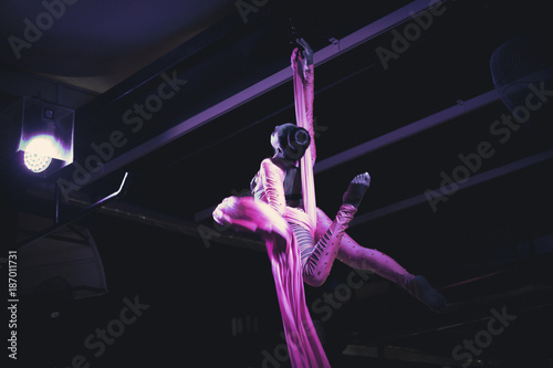 foreign woman making aerial silks skill showing in night club