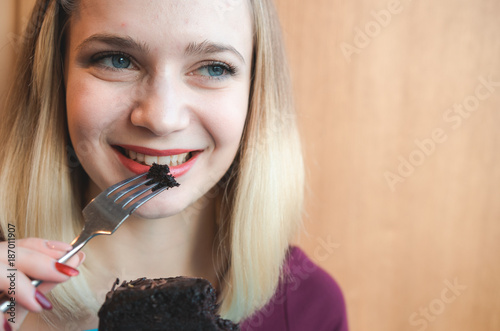 Portrait of pretty young girl with a chocolate cake