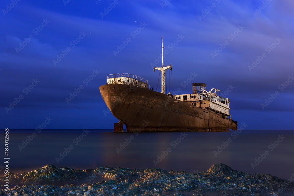 Rusty ship at night