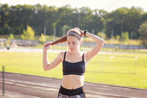 Girl is ready to start her morning exercises on a stadium